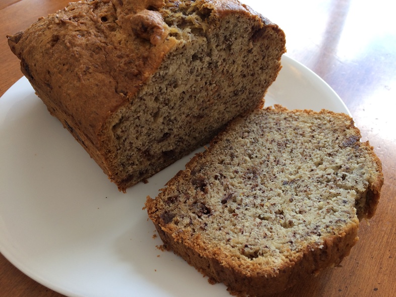 Loaf of Gluten-Free Banana Bread with a slice on a plate.